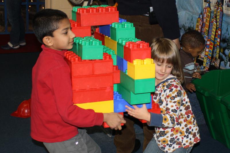 Children building things together with lego