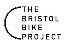 Image is the picture of a bike wheel and across the right hand side of it is written The Bristol Bike Project