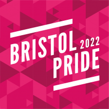 Bristol Pride logo in white in front of pink triangles