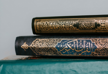 Religious texts in Islam laid on blue table